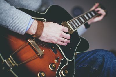 A picture of someone playing a guitar